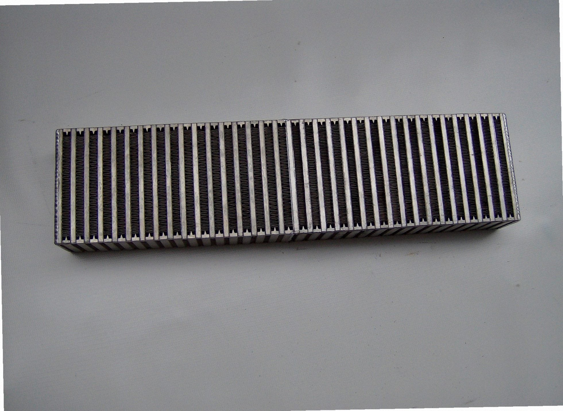 Custom Air-to-Air IC 3 1/2" — passenger-side header with V-band flange and merge collector