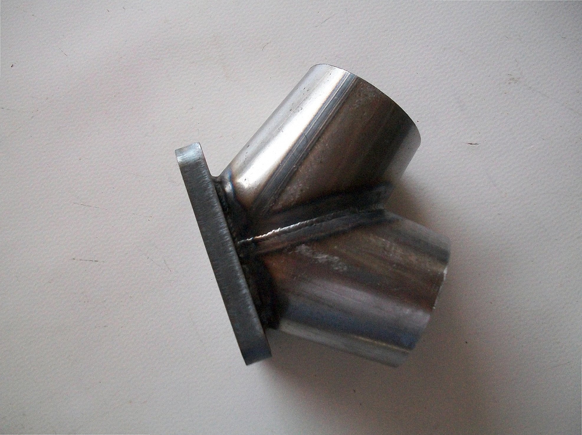TO4 Turbo Mount Flange — alternate angle showing flange thickness, bolt pattern, and weld bevel