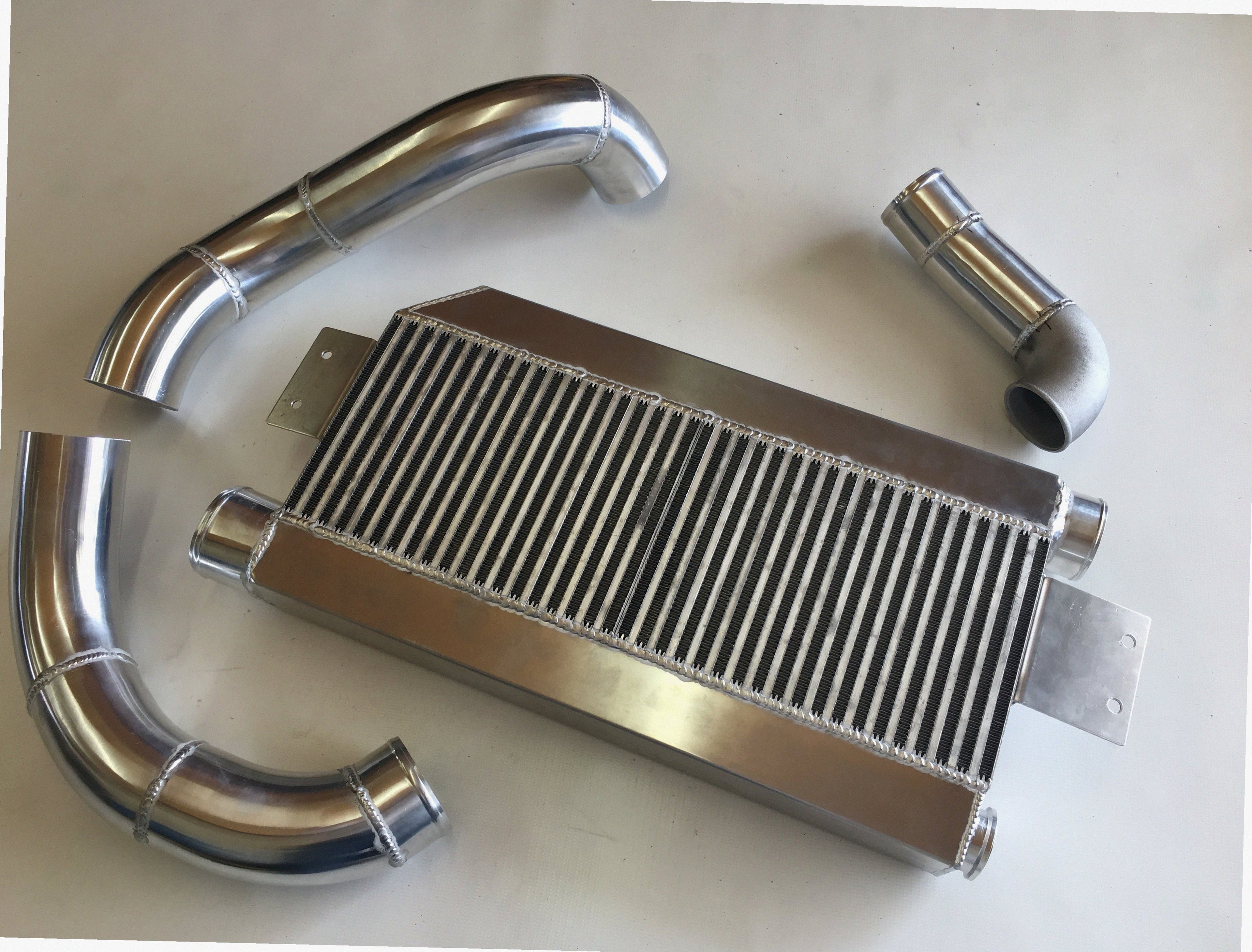 5.0 Coyote Single TO6 Turbo 15-18 Intercooler Kit — aluminum bar-and-plate intercooler core with mandrel-bent aluminum cold-side piping