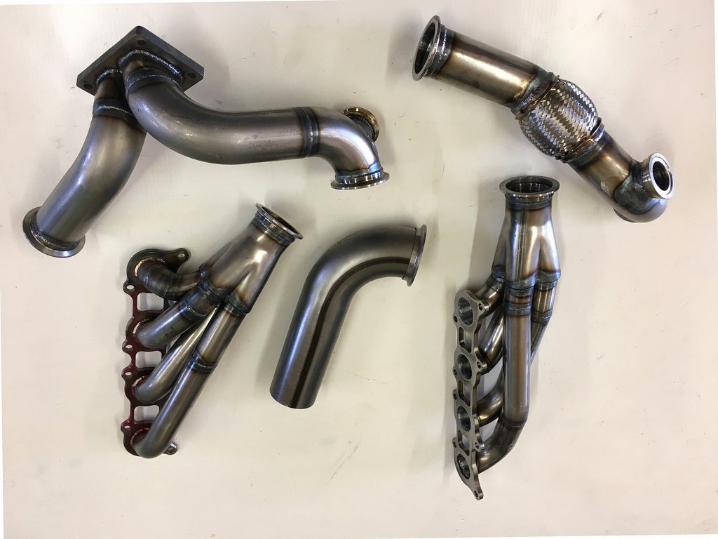 5.0 Coyote 10-14 TO4 Turbo Street/Drag Kit — complete turbo hot-side kit with mild steel tubular headers, crossover pipe with flex bellow, starter downpipe, and turbo mount flange