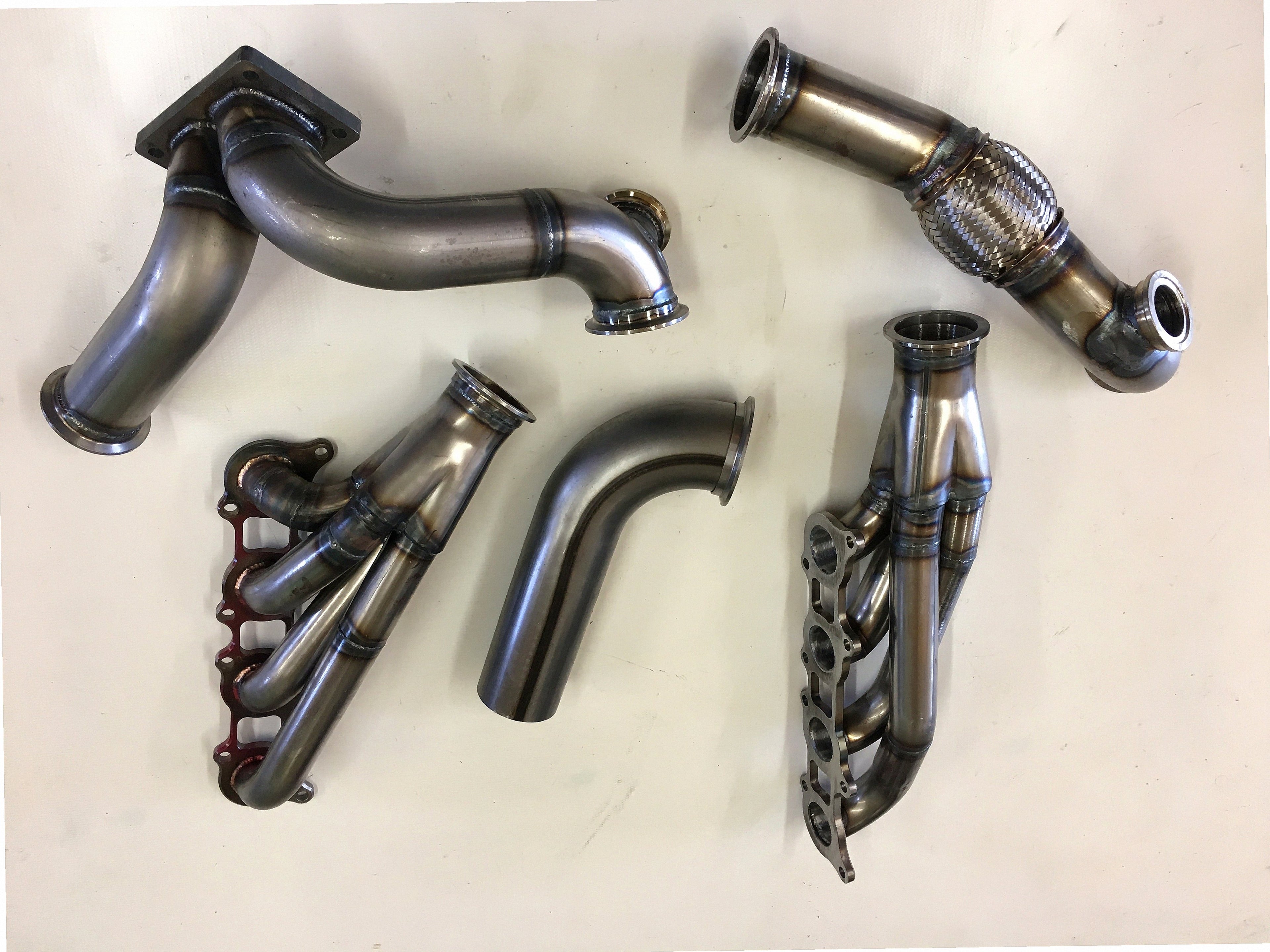 5.0 Coyote 10-14 TO4 Turbo Street/Drag Kit — complete turbo hot-side kit with mild steel tubular headers, crossover pipe with flex bellow, starter downpipe, and turbo mount flange