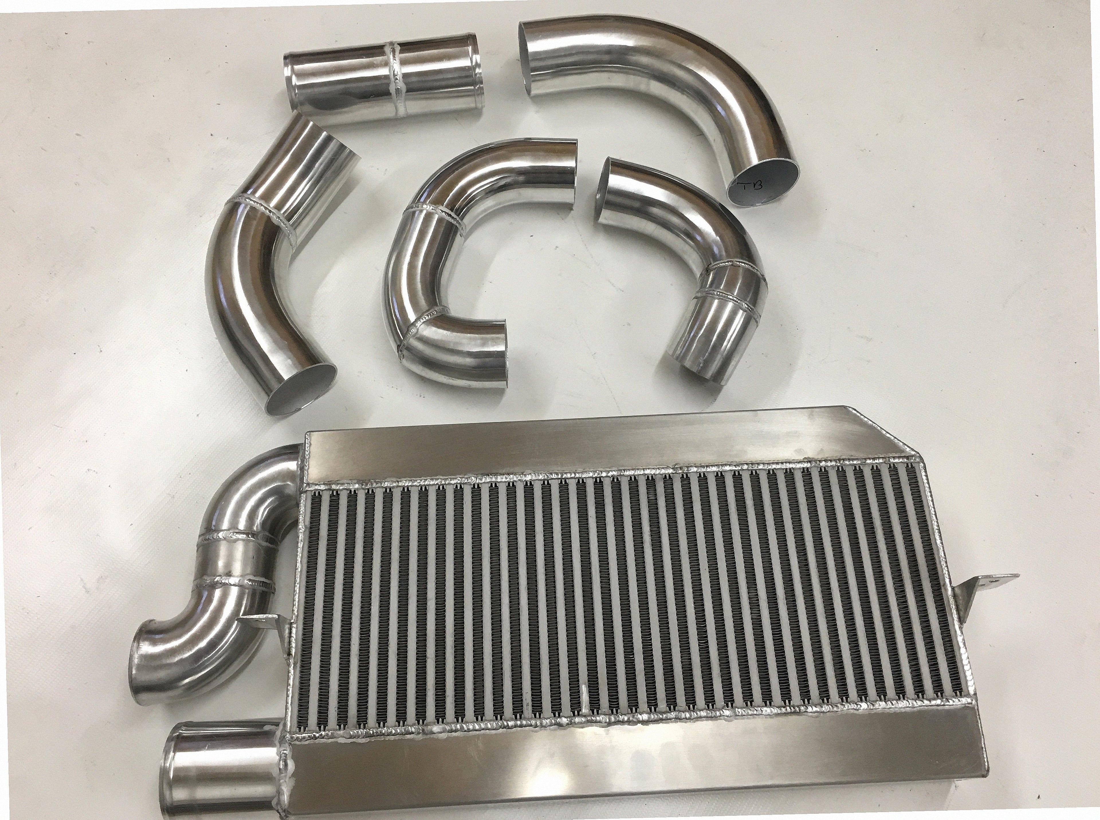Single Turbo 2V Intercooler Kit — aluminum bar-and-plate intercooler core with mandrel-bent aluminum cold-side piping