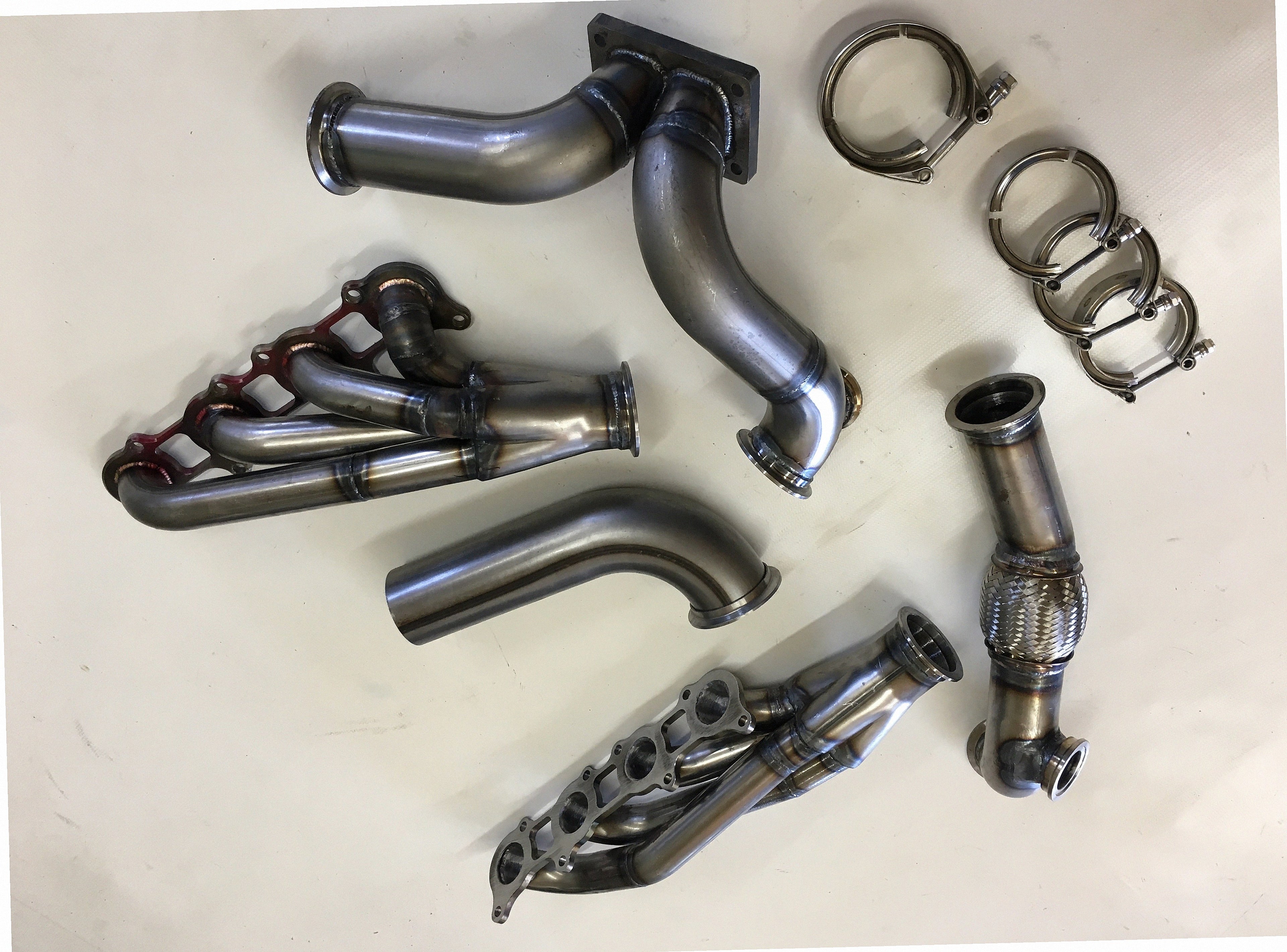 5.0 Coyote 10-14 TO4 Turbo Street/Drag Kit — detail view of merge collector, flex bellow joint, and V-band connection
