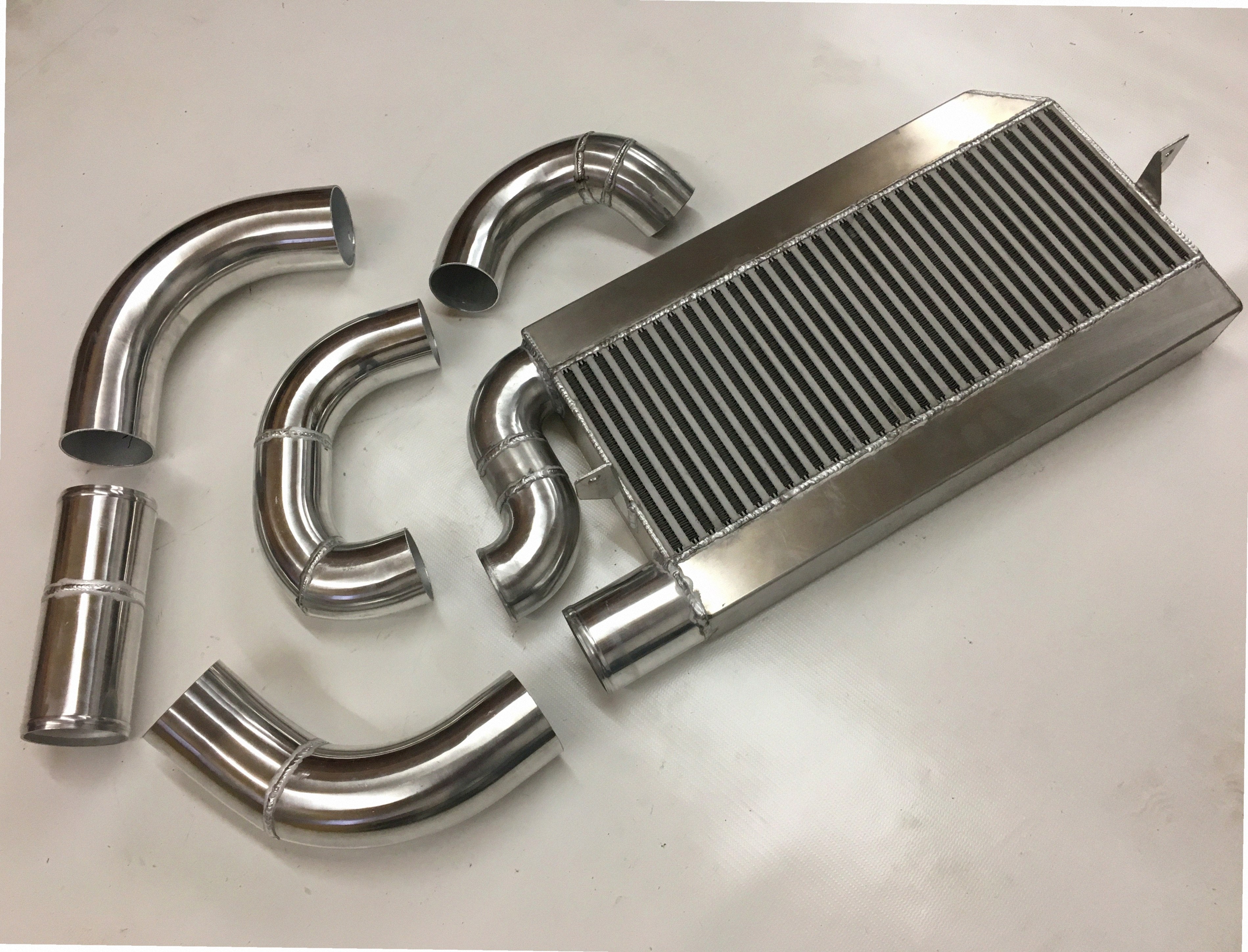 Single Turbo 4V Intercooler Kit — intercooler core detail showing bar-and-plate fin density and TIG-welded seams