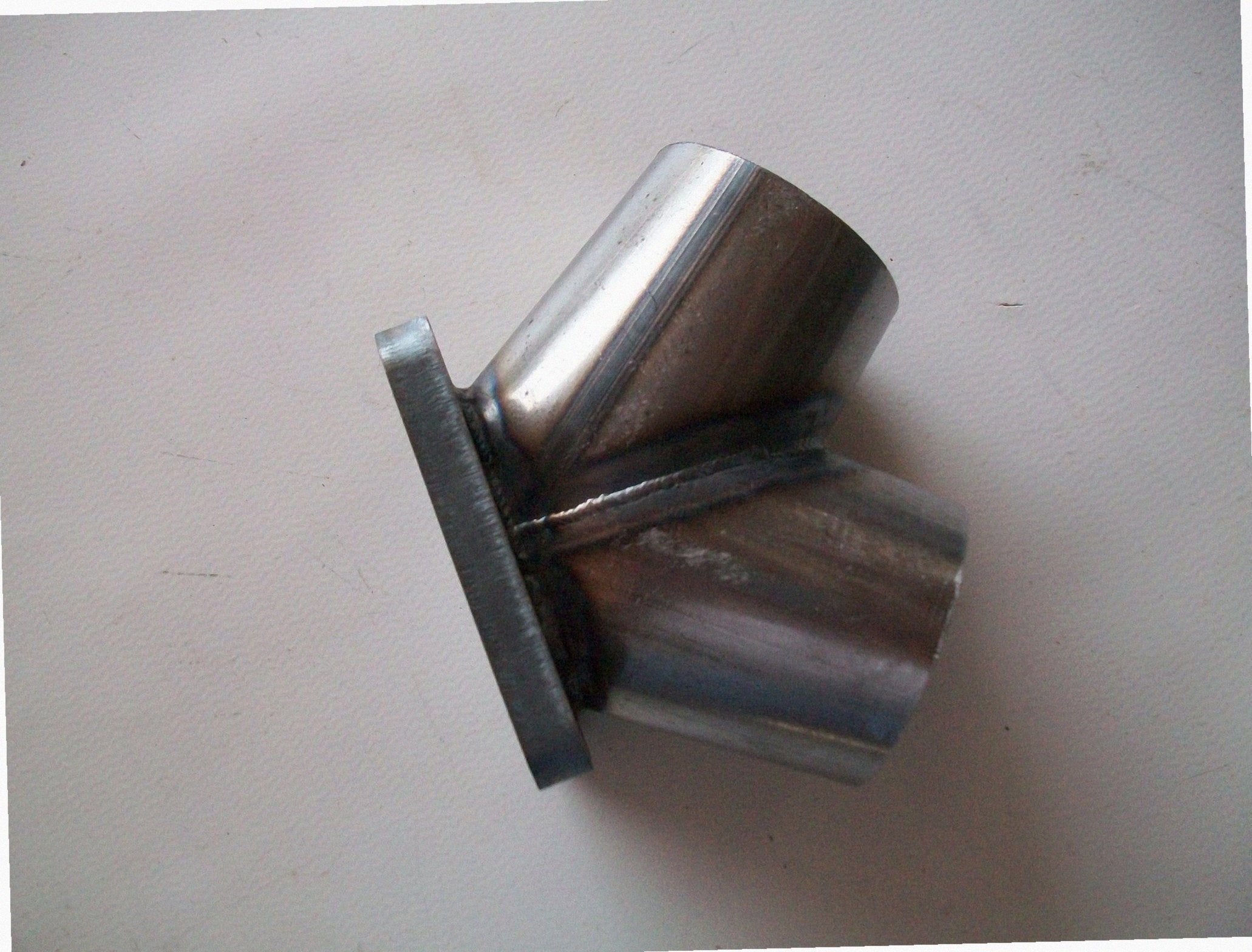 TO6 Turbo Mount Flange — alternate angle showing flange thickness, bolt pattern, and weld bevel