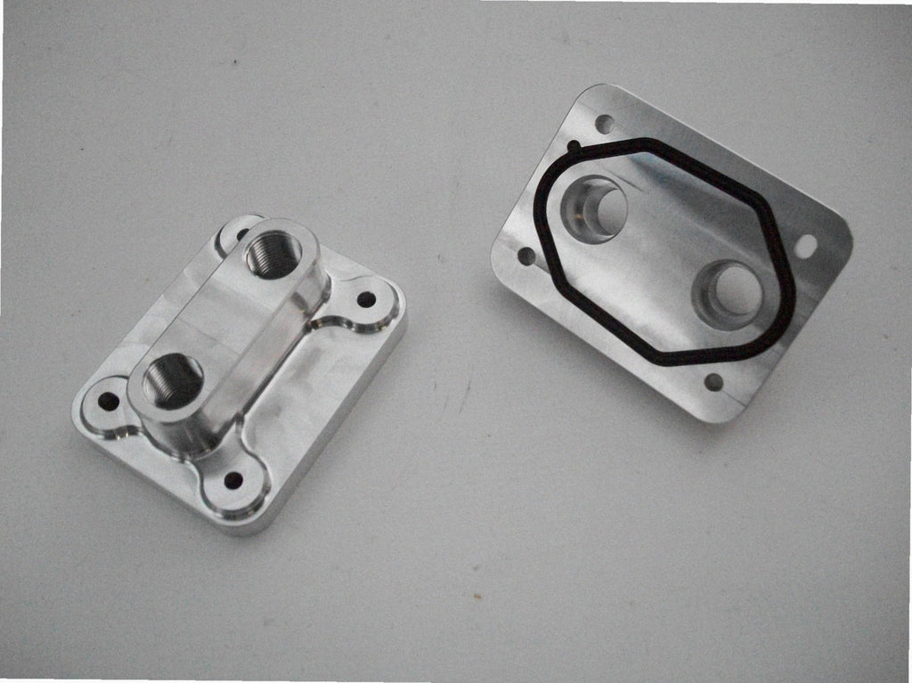 5.4 Water Inlet / Outlet — backside of billet water plate showing coolant passages and gasket surface