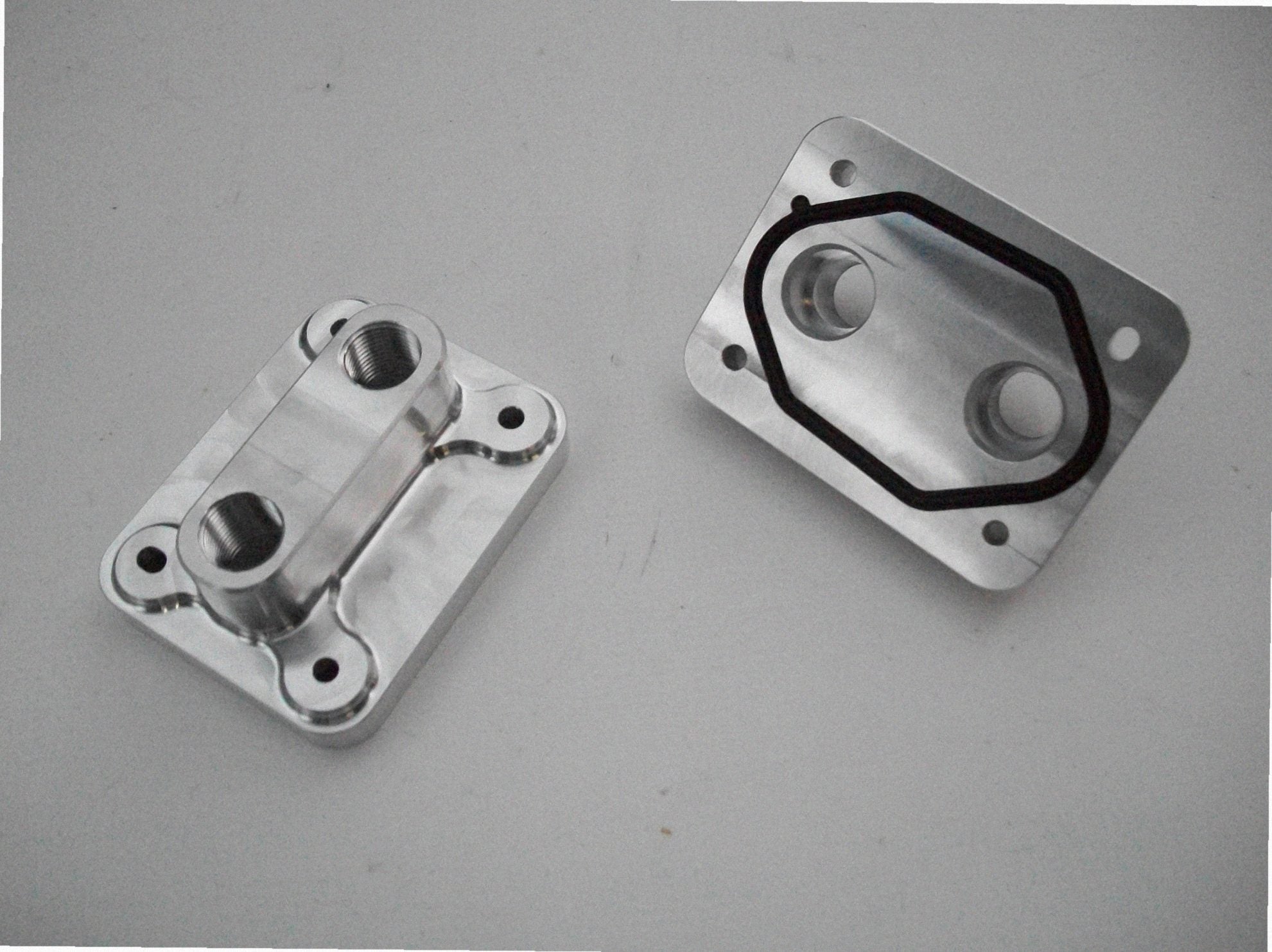 5.4 Water Inlet / Outlet — backside of billet water plate showing coolant passages and gasket surface