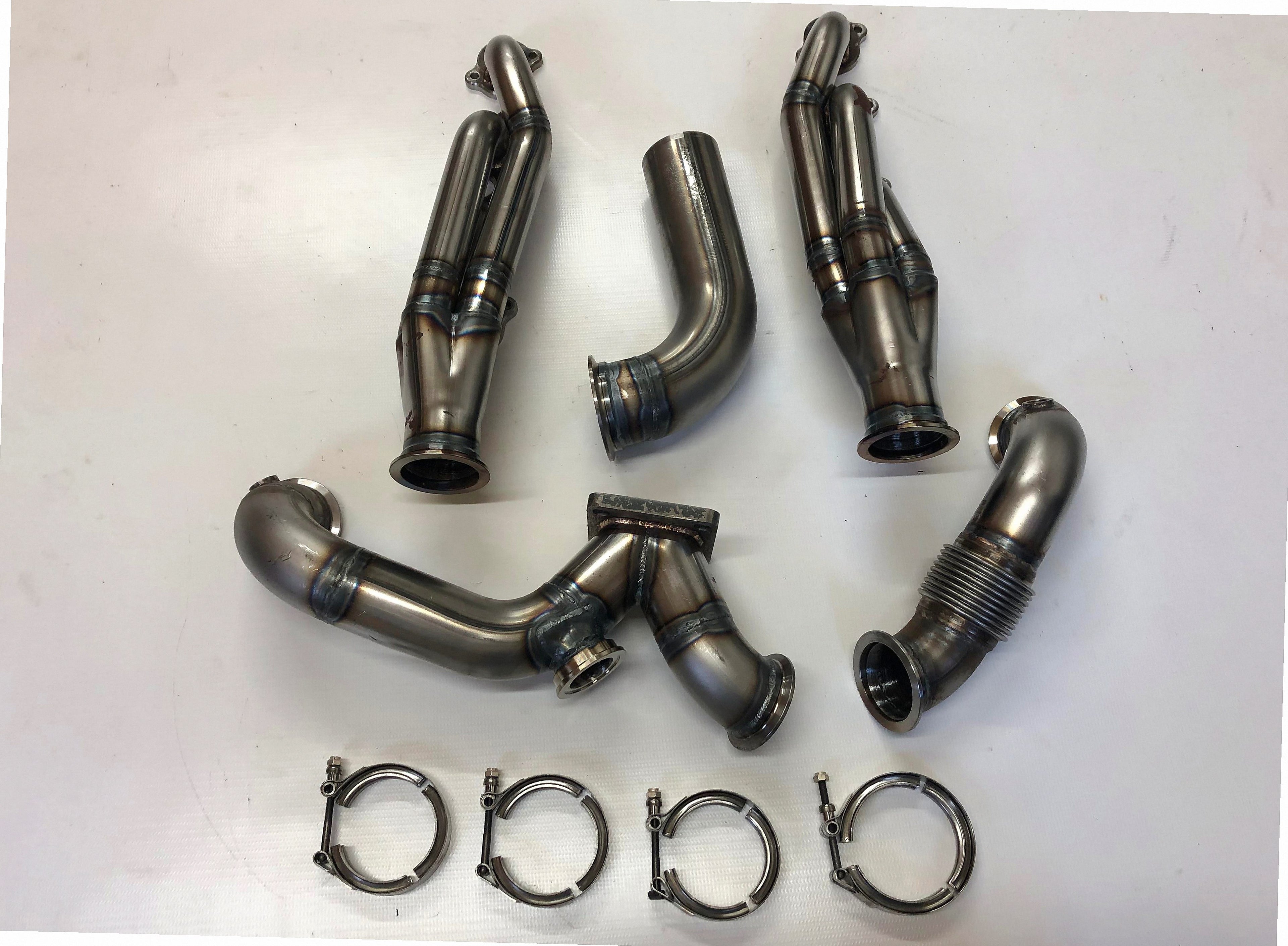 5.4 4V Turbo Street / Drag Kit A/C Delete — detail view of merge collector, flex bellow joint, and V-band connection