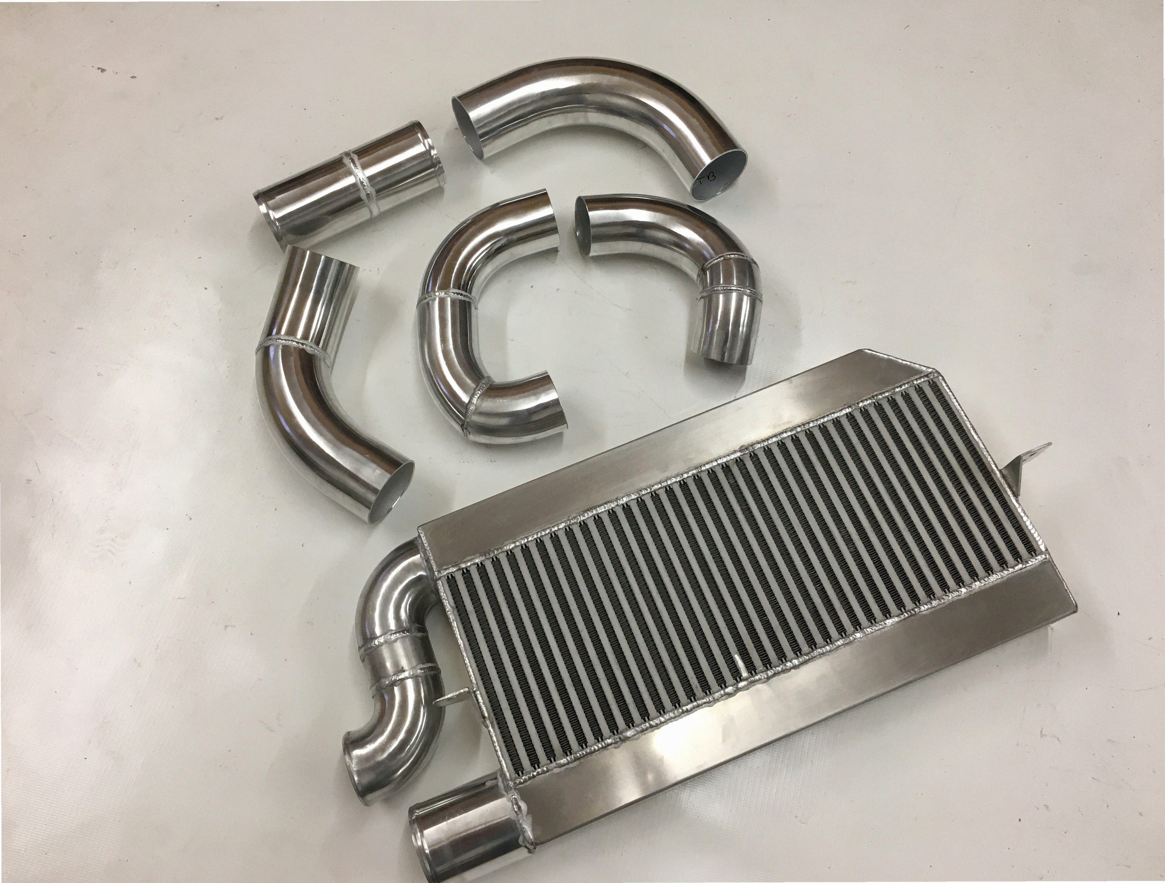 Single Turbo 2V Intercooler Kit — intercooler core detail showing bar-and-plate fin density and TIG-welded seams