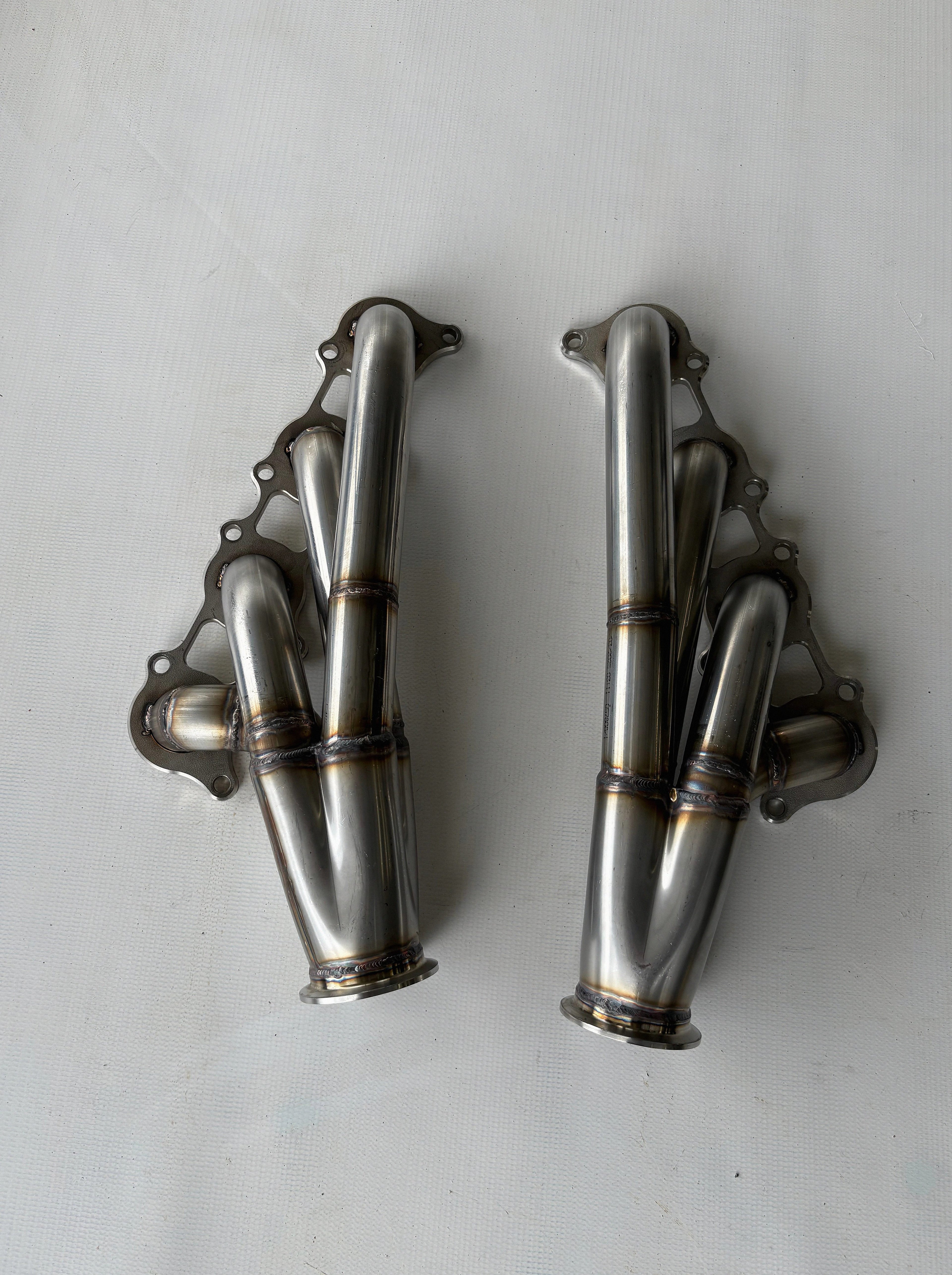 Coyote Swap Turbo Headers Up — complete turbo hot-side kit with mild steel tubular headers, crossover pipe with flex bellow, starter downpipe, and turbo mount flange