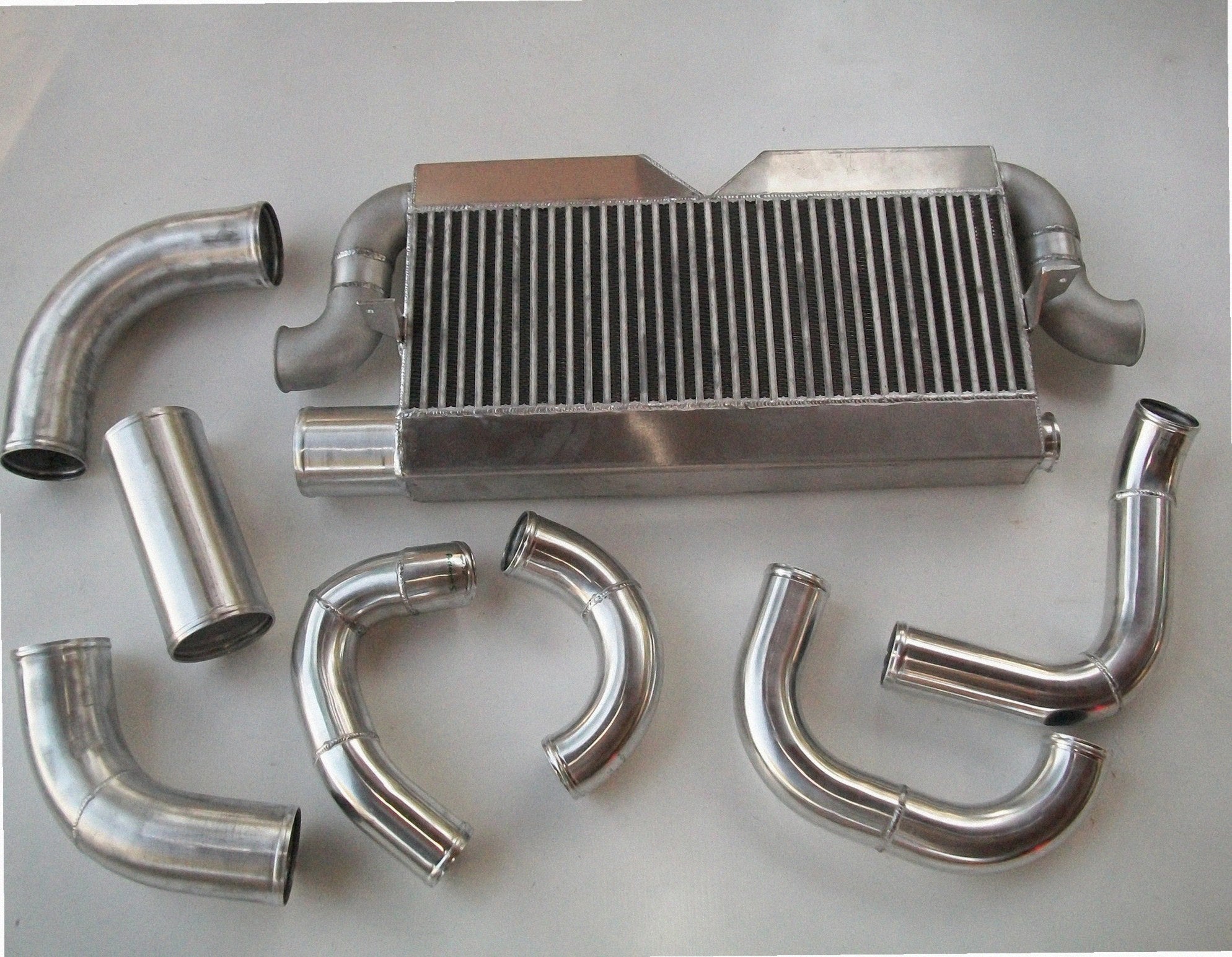 Twin Turbo 2V Intercooler Kit — intercooler core detail showing bar-and-plate fin density and TIG-welded seams