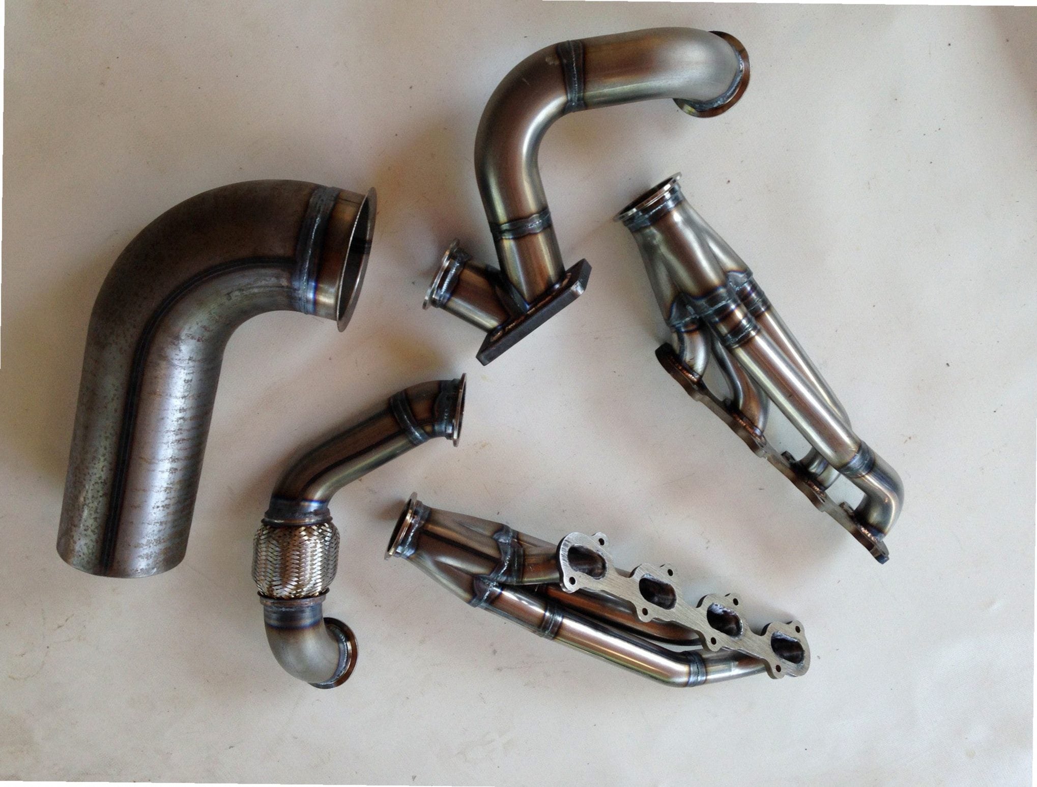 Modular 4V TO6 Turbo Race Kit — passenger-side header with V-band flange and merge collector