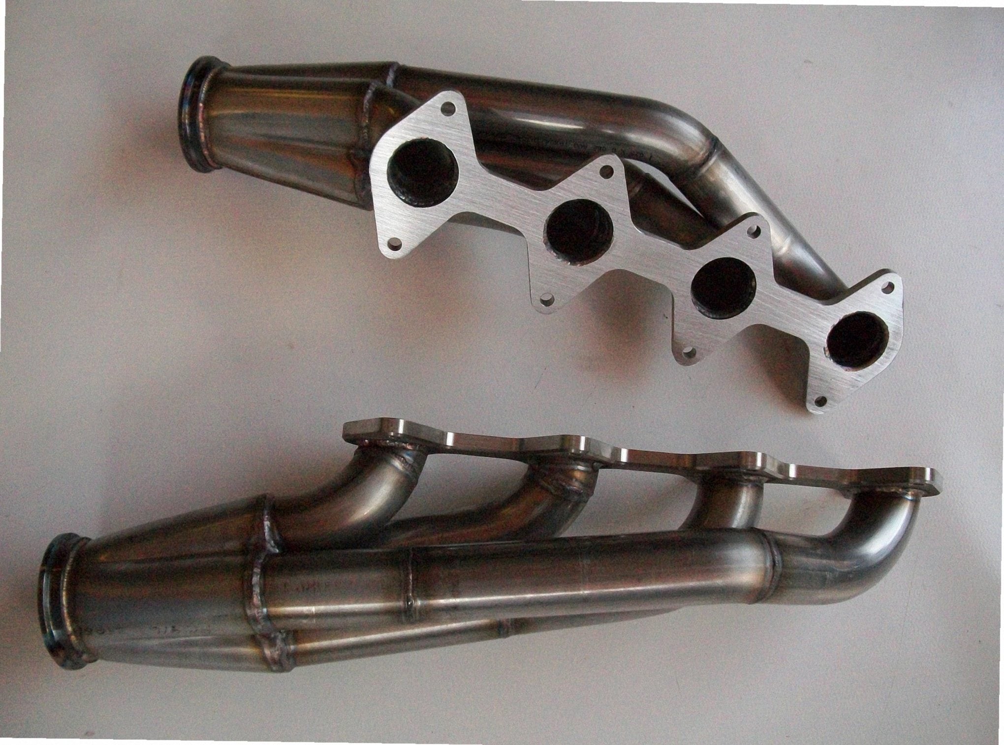 3 Valve Racing Turbo Headers — passenger-side header with V-band flange and merge collector