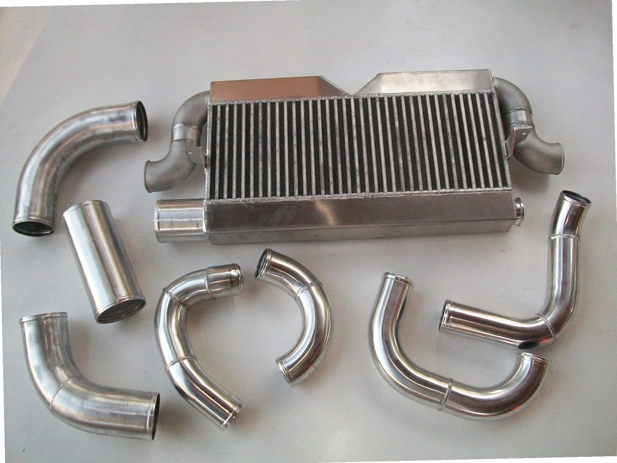 Twin Turbo 4V Intercooler Kit — intercooler core detail showing bar-and-plate fin density and TIG-welded seams