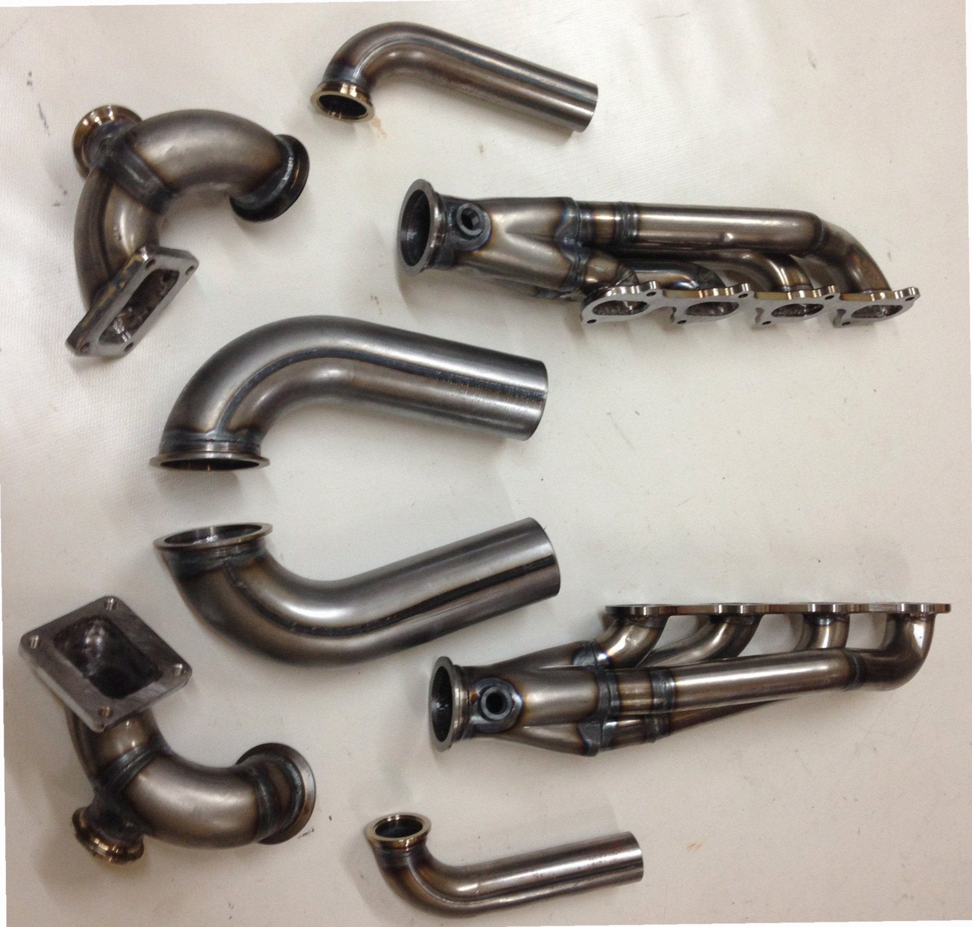 5.4 4V Twin Turbo Hotside — complete turbo hot-side kit with mild steel tubular headers, crossover pipe with flex bellow, starter downpipe, and turbo mount flange