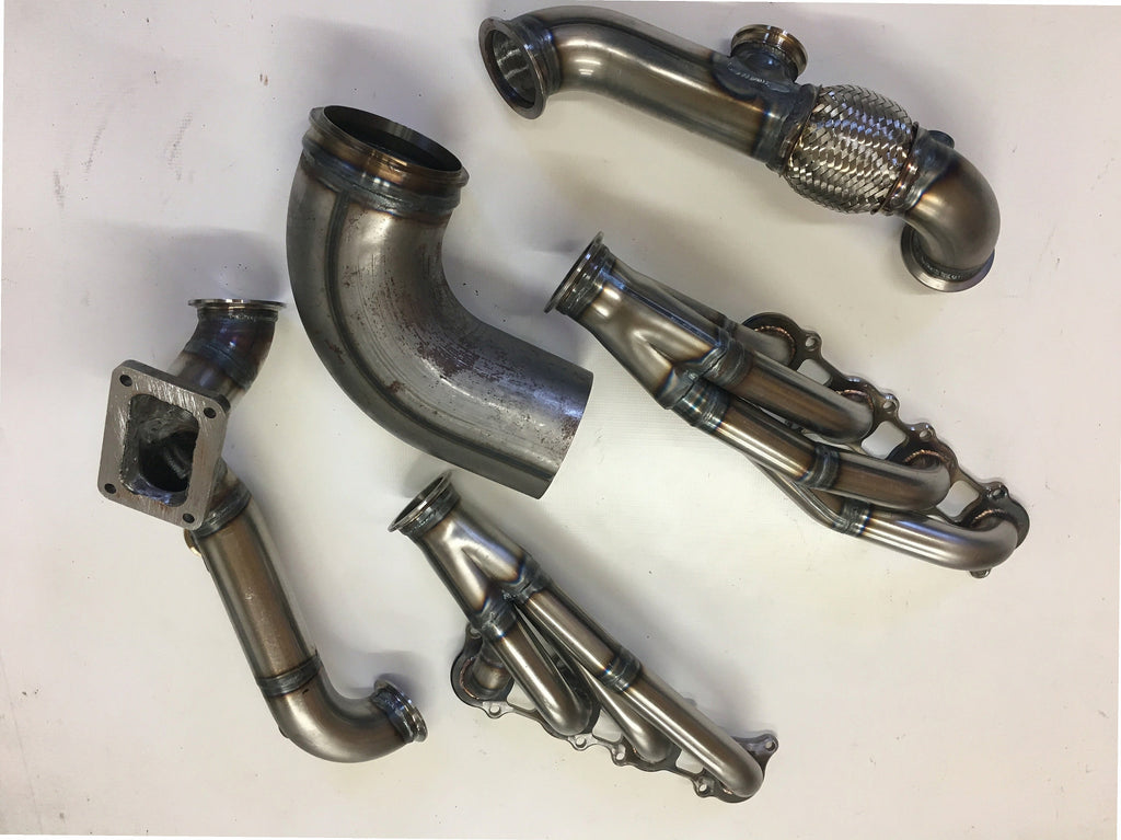 5.0 Coyote 10-14 TO6 Turbo Race Kit — complete turbo hot-side kit with mild steel tubular headers, crossover pipe with flex bellow, starter downpipe, and turbo mount flange